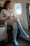 Sigvaris® Traveno Reise-Stützsocken in schönem blau, Frau im Flugzeug